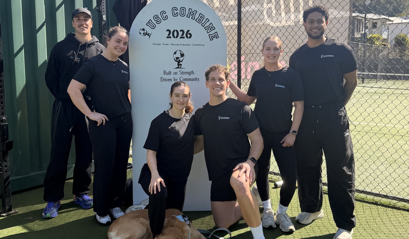 The USC coaching team on the turf